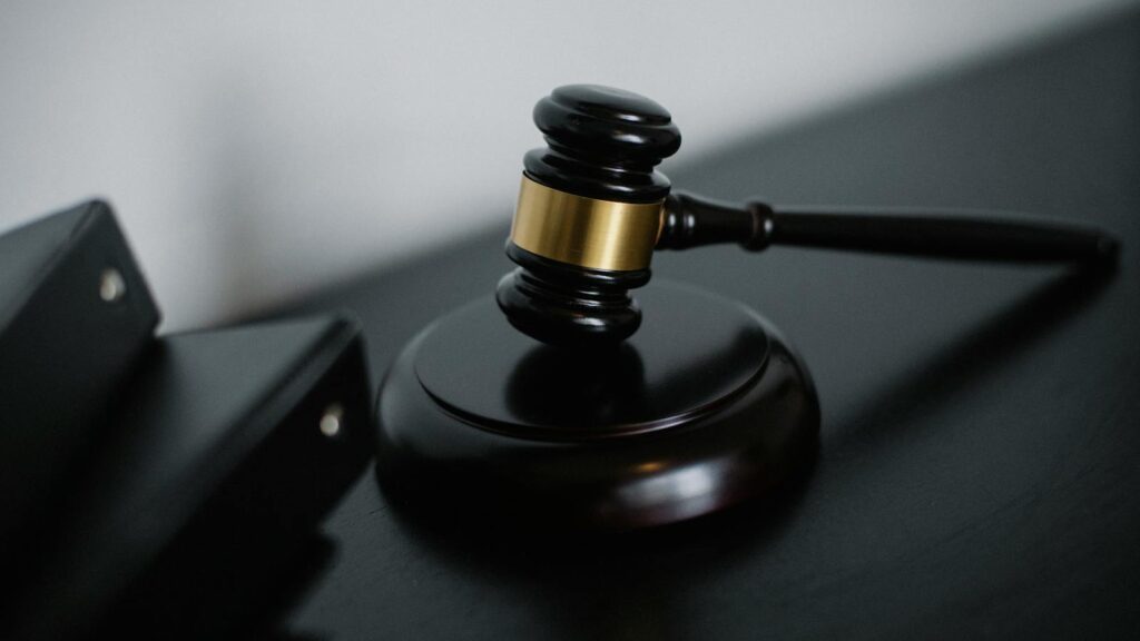 Close-up of a wooden gavel on a desk, symbolizing justice and legal authority.