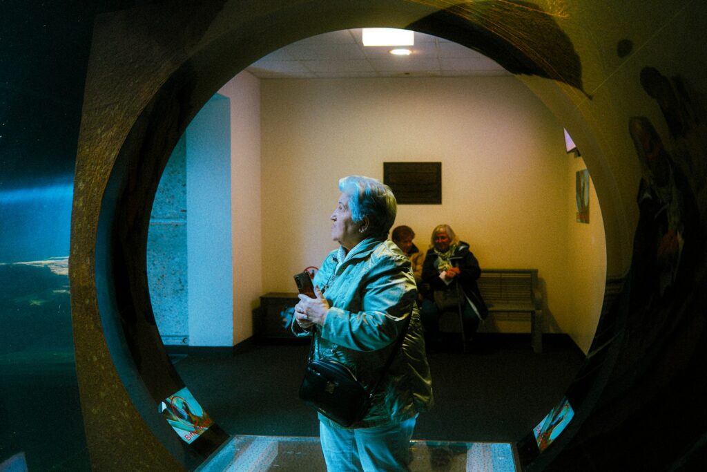 People stand inside of a round opening.