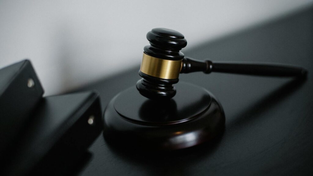 Close-up of a wooden gavel on a desk, symbolizing justice and legal authority.