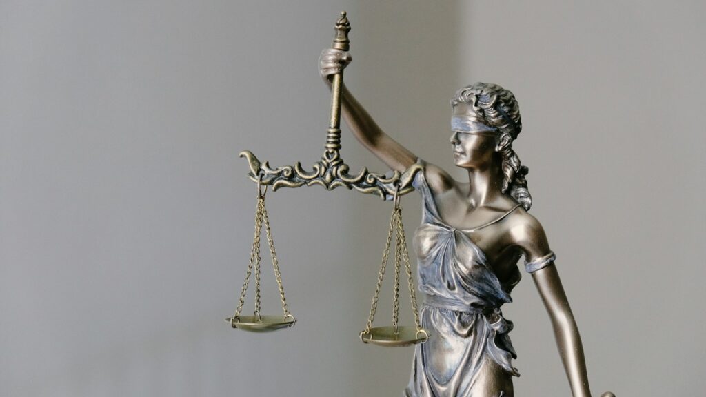 Blindfolded Lady Justice statue symbolizing law and impartiality.